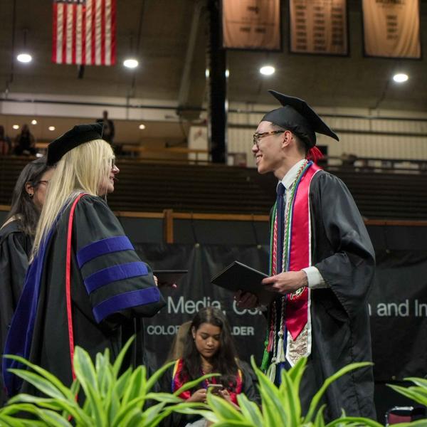 CMCI Founding Dean Lori Bergen congratulates a graduate.