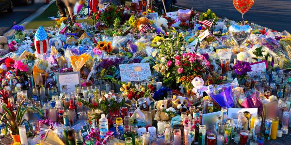 A memorial in Las Vegas, with flowers, balloons, photos and candles, to honor victims of a mass shooting.