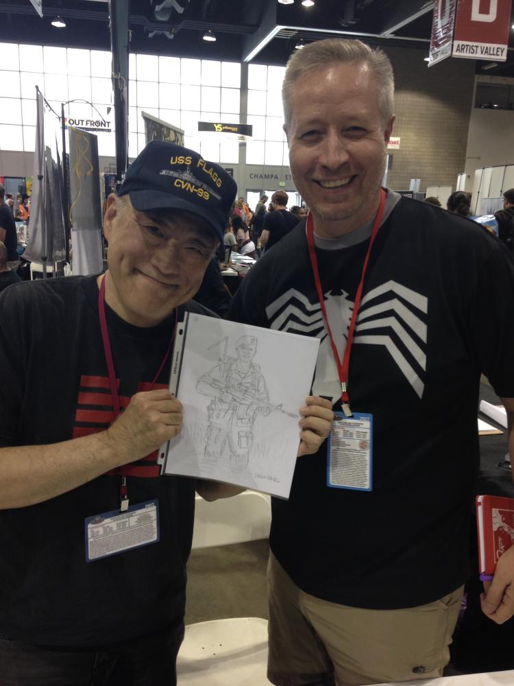 Marvel and IDW writer Larry Hama, who Stevens interviewed for his upcoming book about Hasbro, presents Stevens with a sketch. 