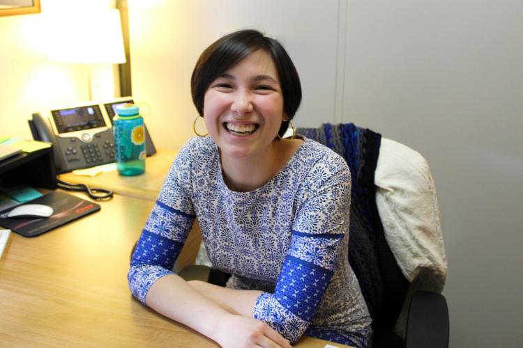 Stephanie Quon sits at her desk in the CMCI Advising Office. Credit: Hannah Prince/CU Boulder