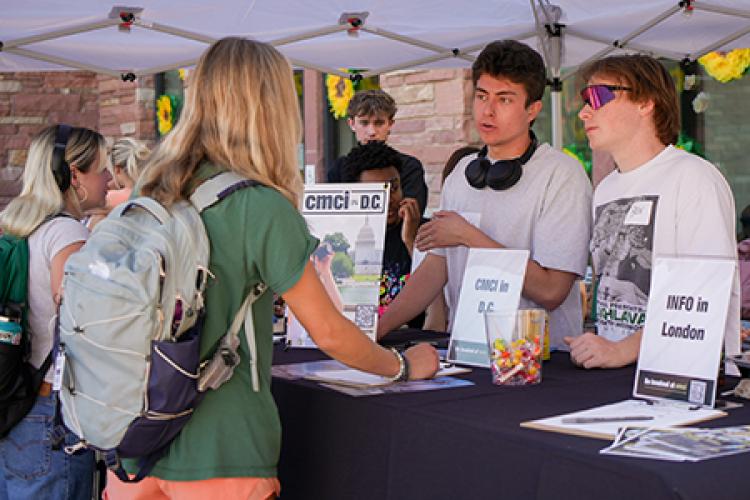 Students lined up to ask questions about study abroad opportunities at the college.