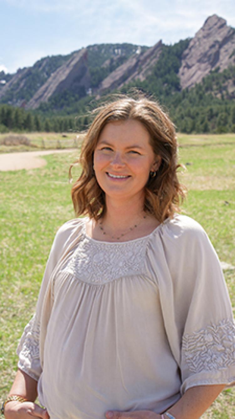 Emily King Kinsey standing on the trail at Chautauqua Park, with the Flatirons in the background.
