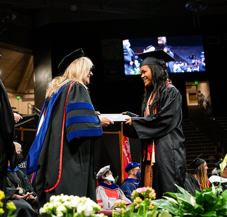 Student accepting her diploma at graduation