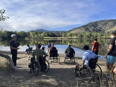 Topher Downham taking students on a wheelchair tour of the Wonderland Lake Trail