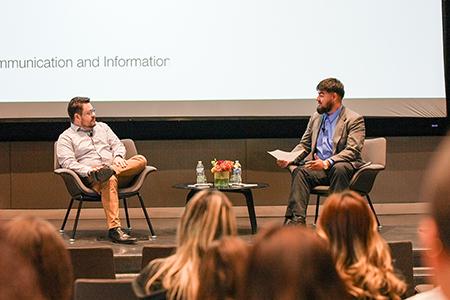A student interviews a Wall Street Journal reporter onstage.