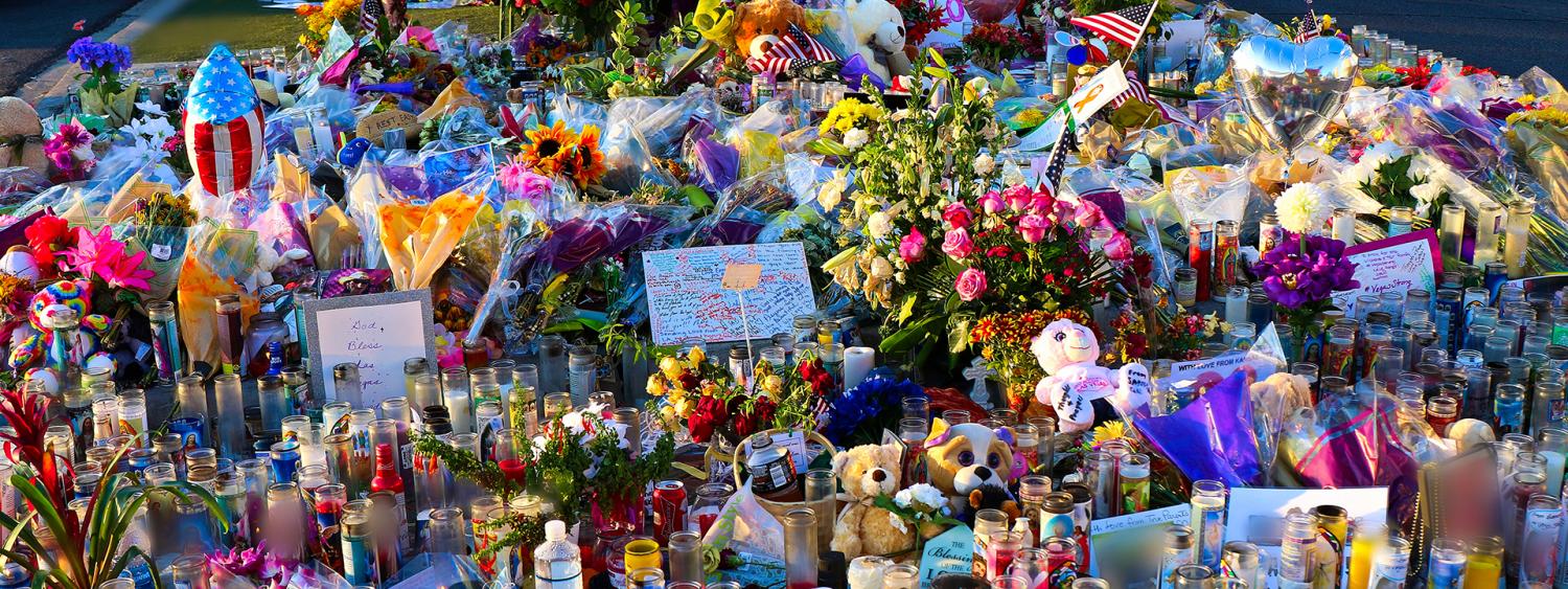 A memorial in Las Vegas, with flowers, balloons, photos and candles, to honor victims of a mass shooting.