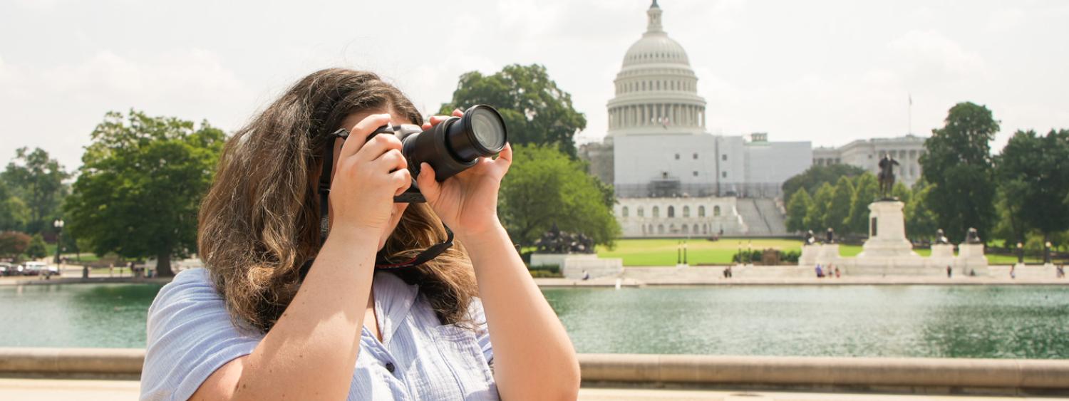 Student takes a picture on the National Mall