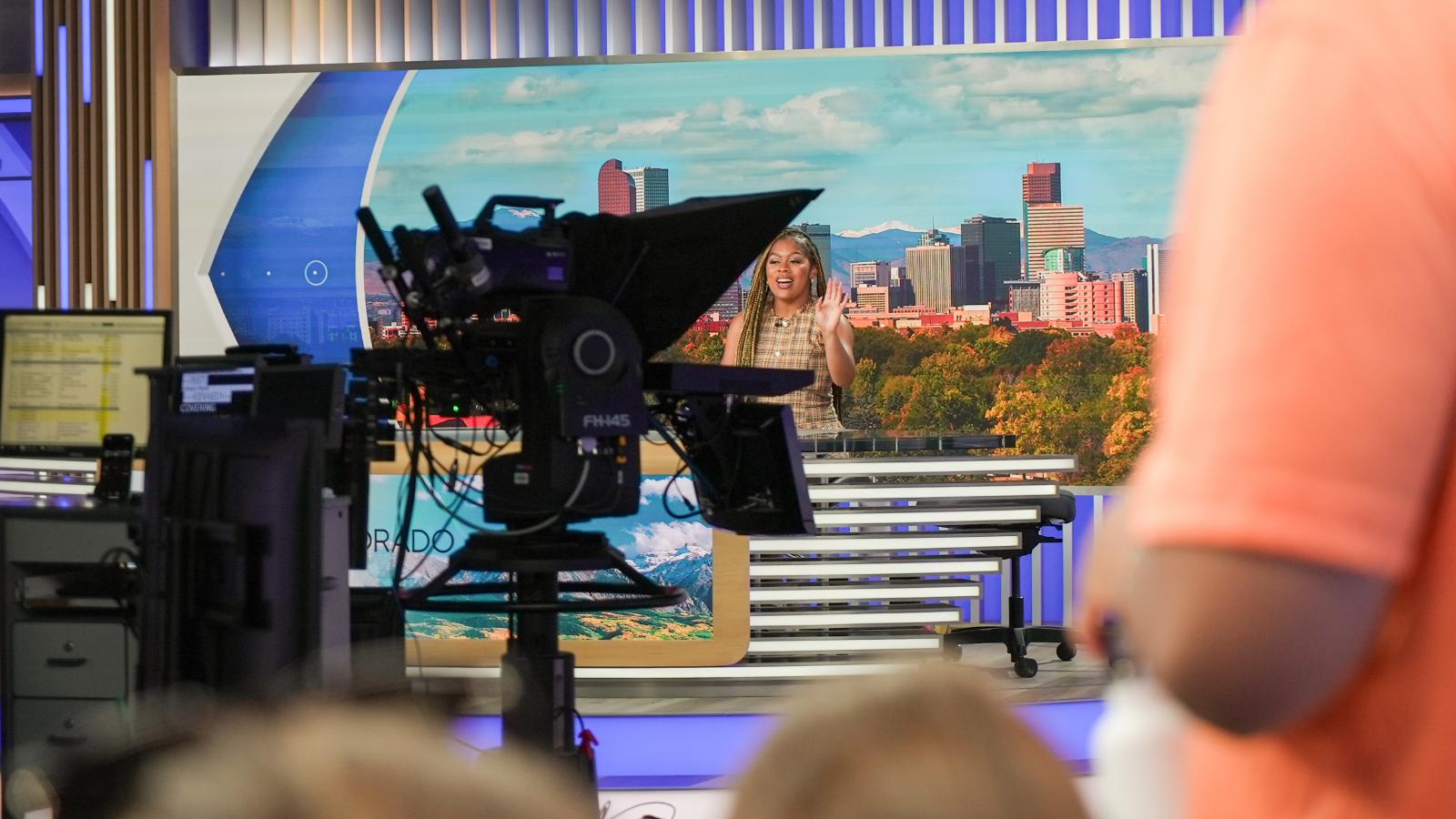 A student behind the anchor's desk at CBS4 Denver.