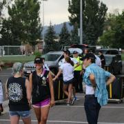 students arrive outside Buckingham Hall as volunteers greet them 