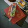 A vintage clear handset phone sitting on top of Lori Emerson's book