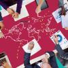 Close up of group of people's hands with world map in the middle