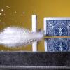 A playing card being split with a bullet