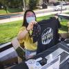 Volunteers pass out Sko Buffs t-shirts during move-in