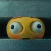 An emoji is squeezed by an industrial press in a still from Apple's controversial new ad.