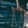 Blindfolded Lady Justice against a computer screen