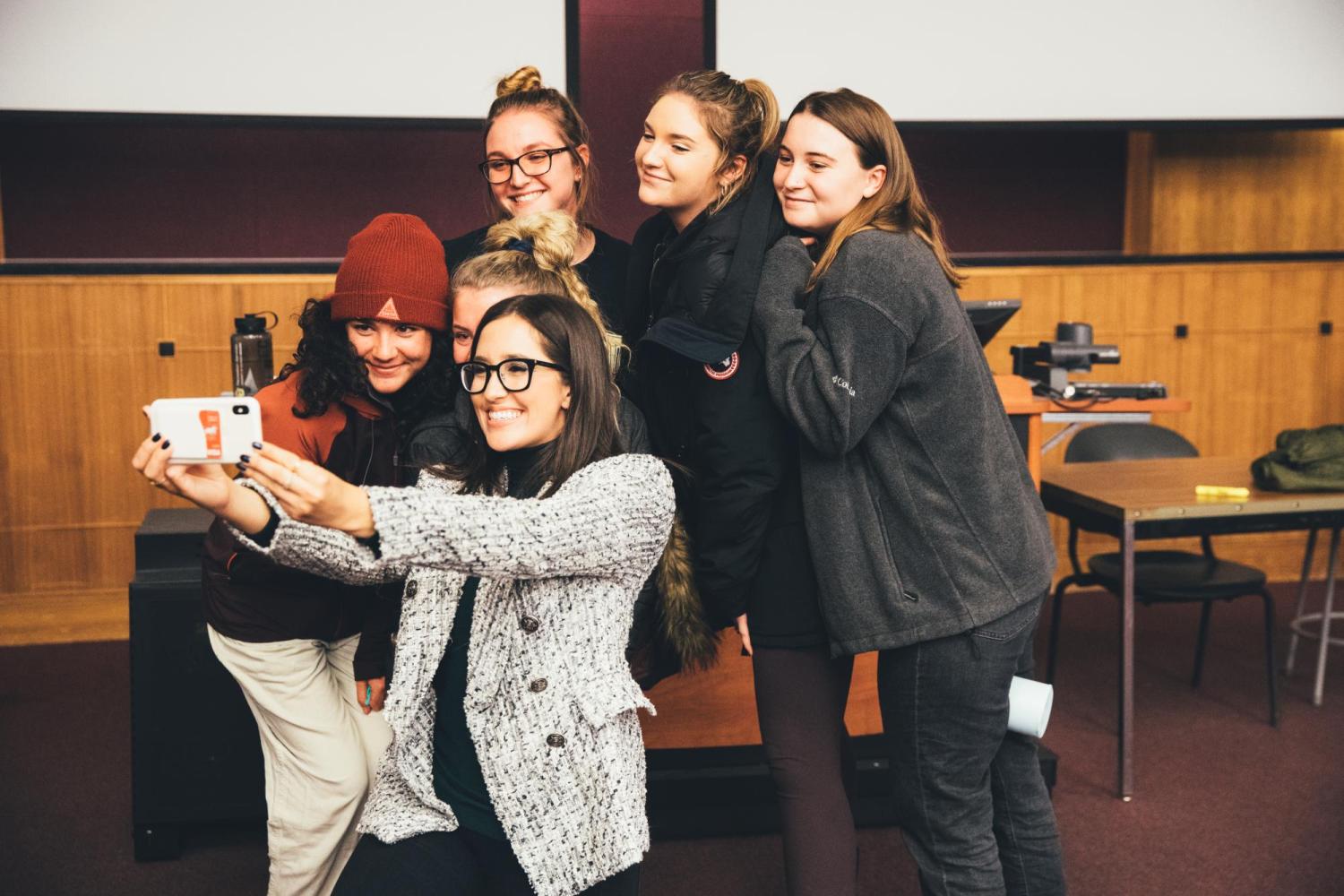 Alumni Savannah Sellers posing for photo with students.