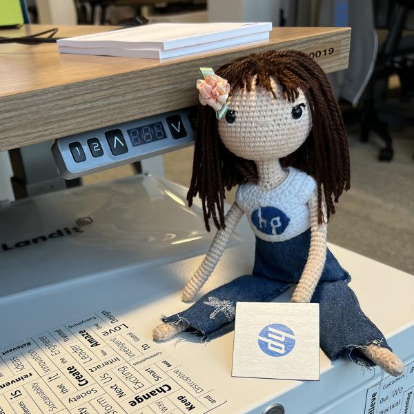 Doll posed on top of printer