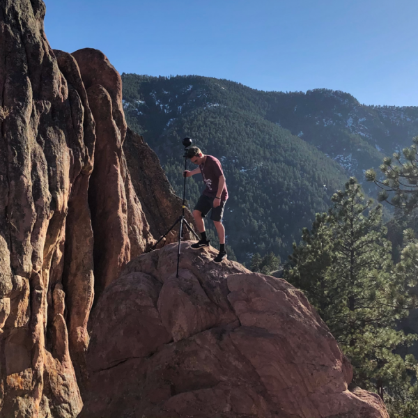 Beau Evans with camera on cliff