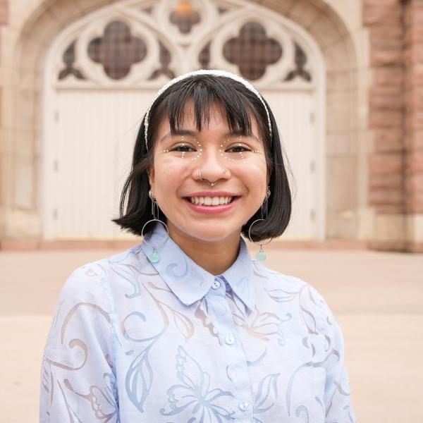 A portrait of Bianca in front of the library.