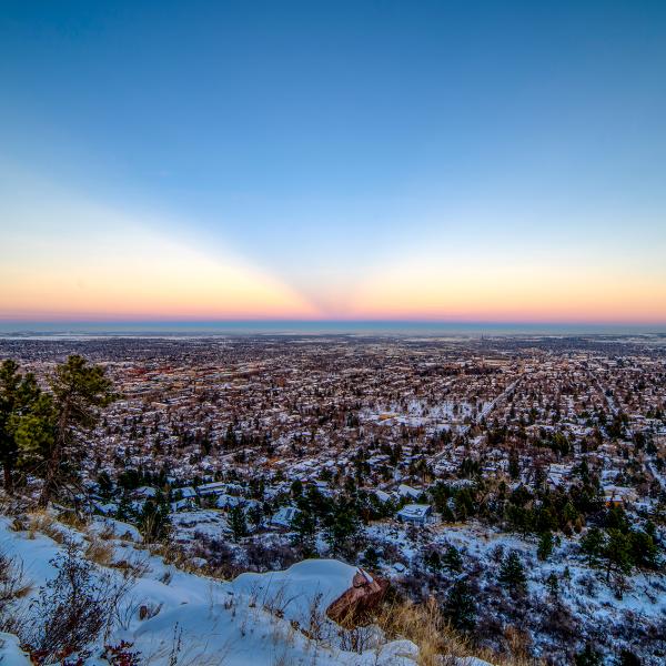 The sun sets on Boulder during the evening of Sunday, Jan. 2, 2022, the day after 8.2 inches of snow fell across the county and helped stem the rapid spread of the Marshall Fire.