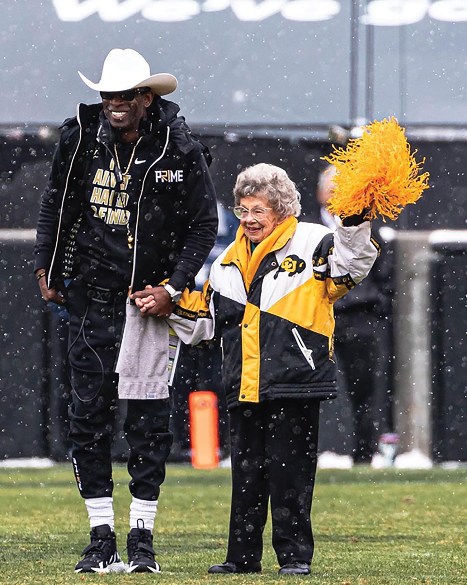 Photo of Coach Prime holding hands with Buffaloes superfan Peggy Coppom