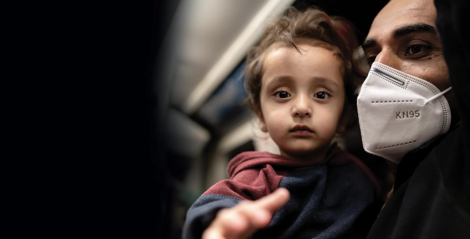 young child reaching for camera