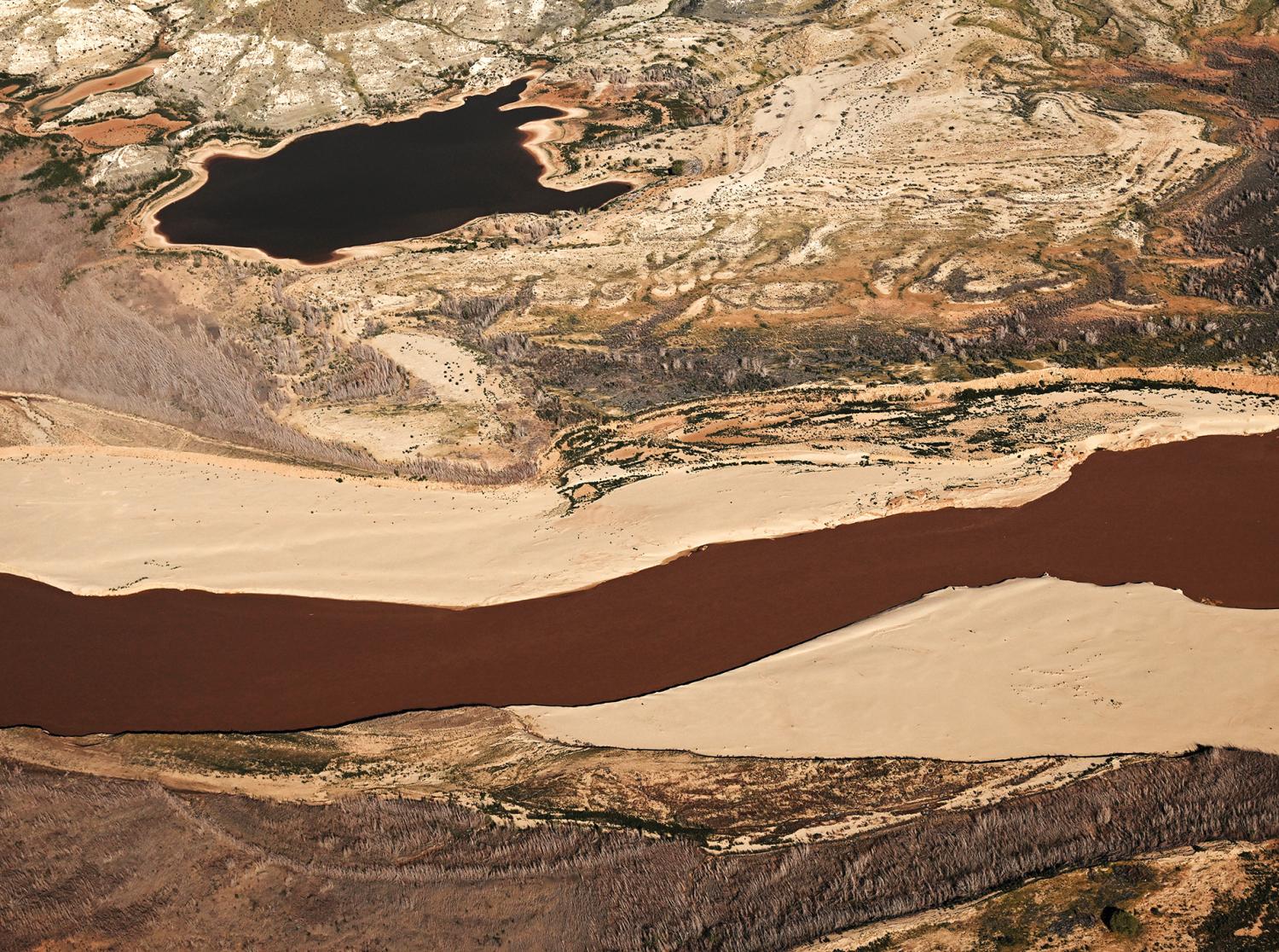 An aerial view of the Colorado River flowing through Gregg Basin, in Nevada, in spring 2023. The river deposits sediment along the banks before flowing into Lake Mead.