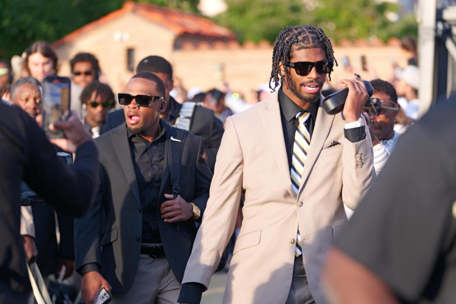 Shedeur Sanders walks around campus.