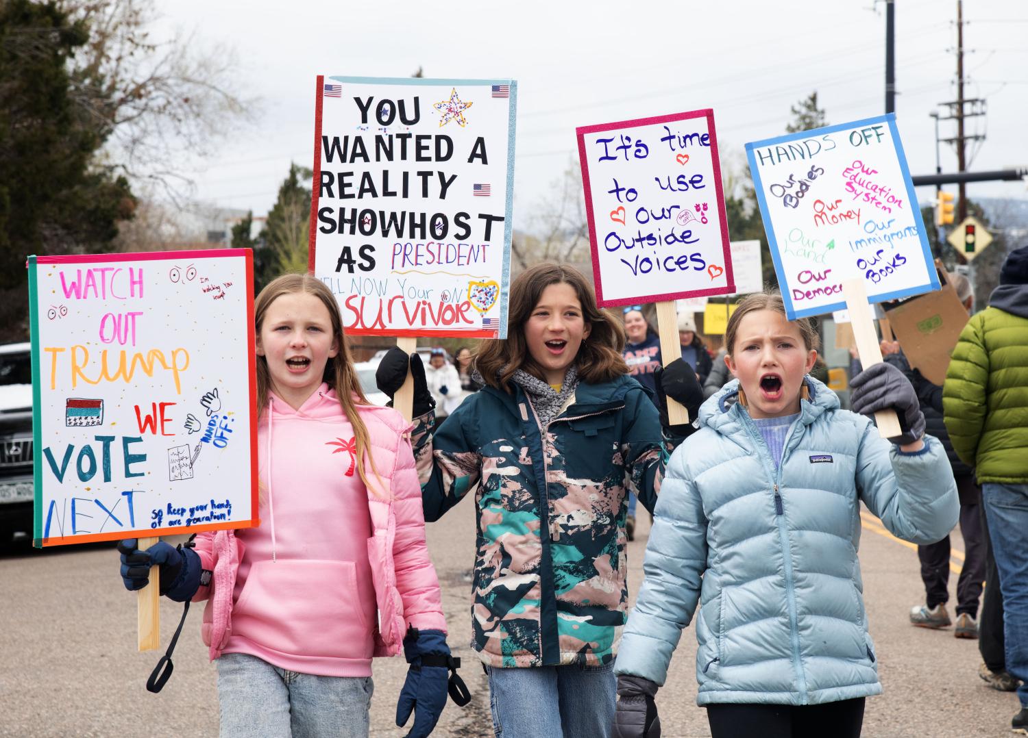 young children holding protest signs