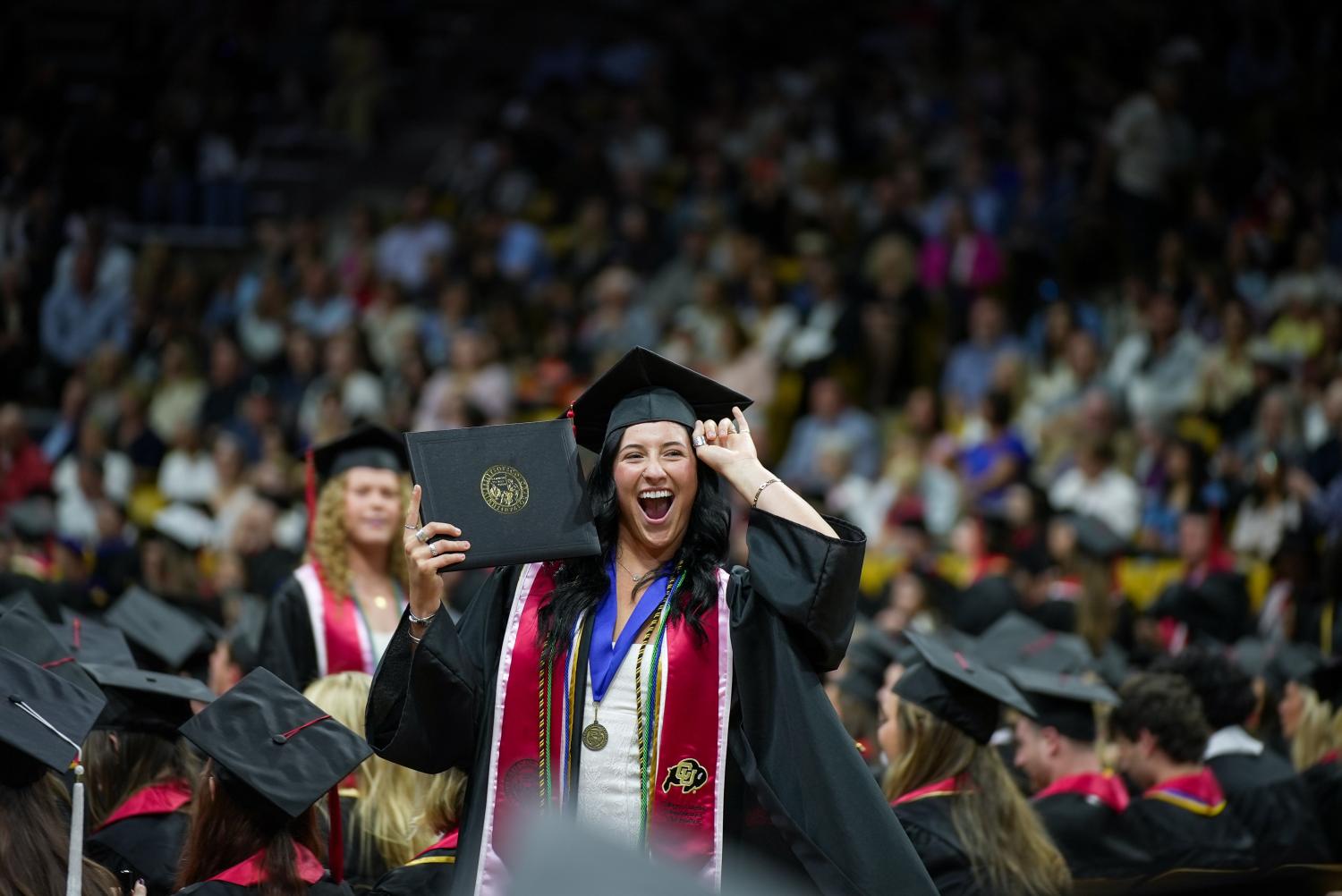 A student celebrates her graduation