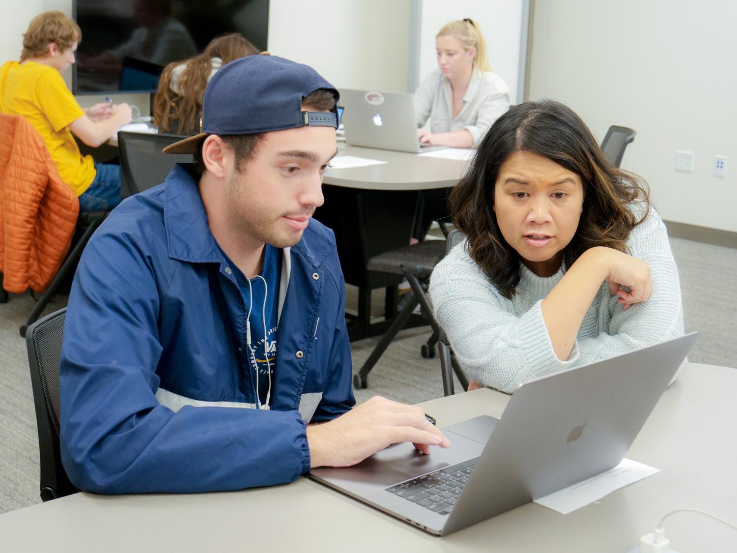 Angie Chuang works with a student.