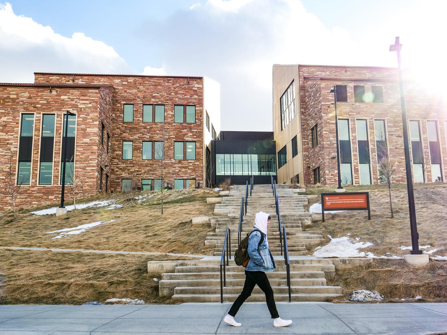 A student walks by the CASE building, home of CMCI's administrative offices, podcast booths, advertising studio and more.