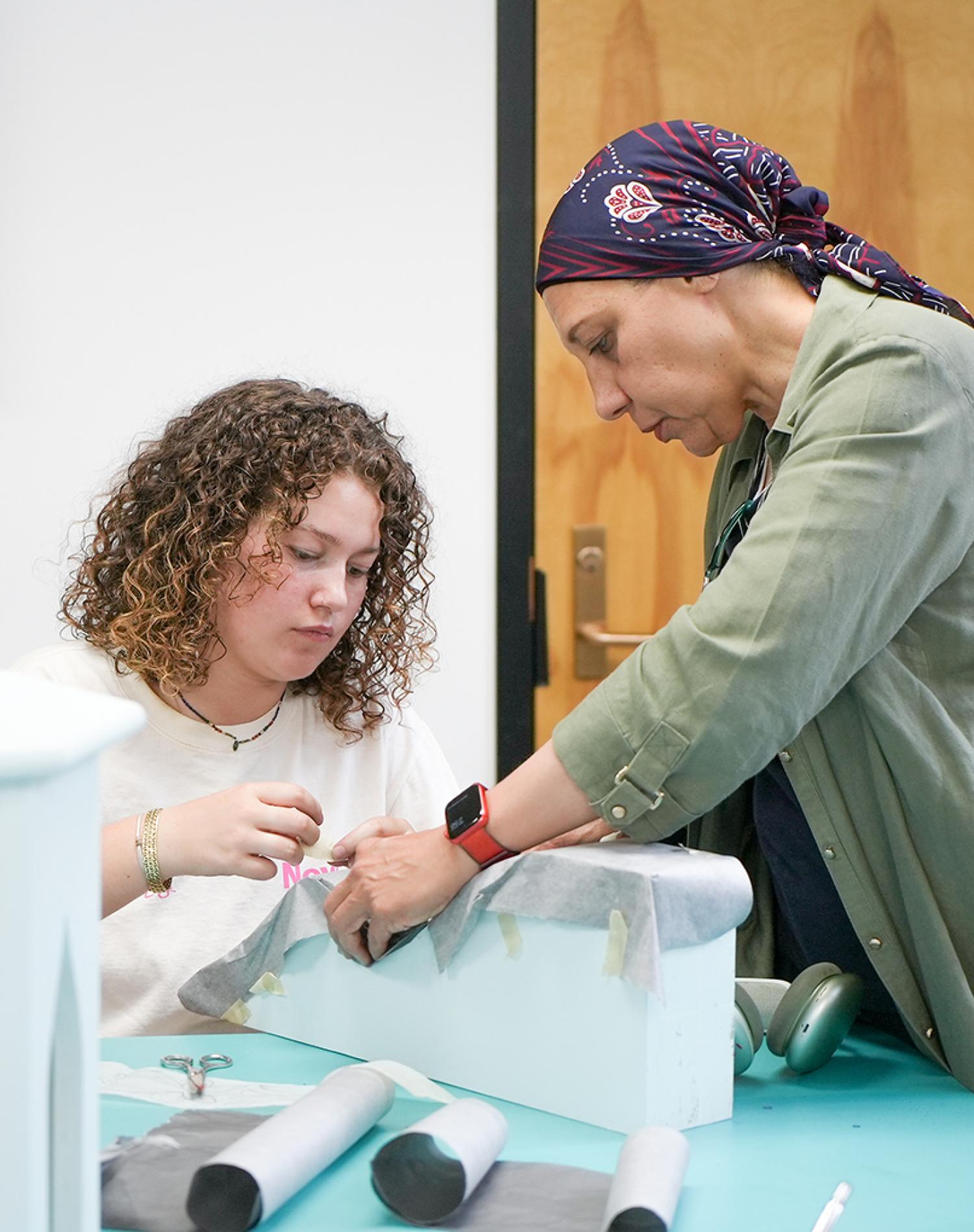 Azza Kamal working with student