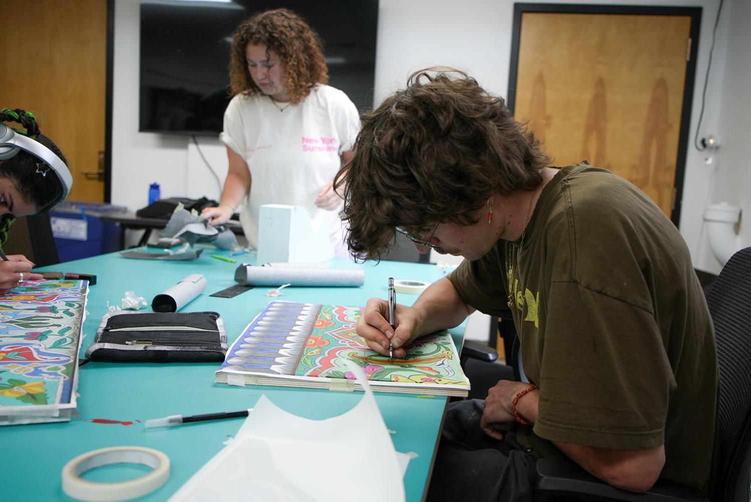 students working on designs for the teahouse