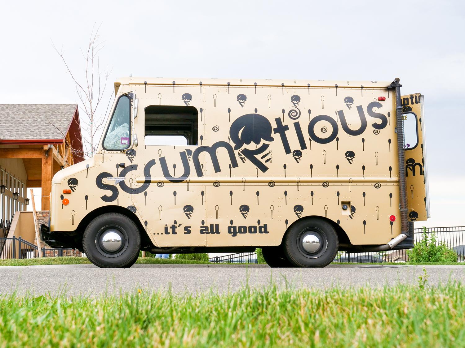 Scrumptious ice cream truck parked in neighborhood.