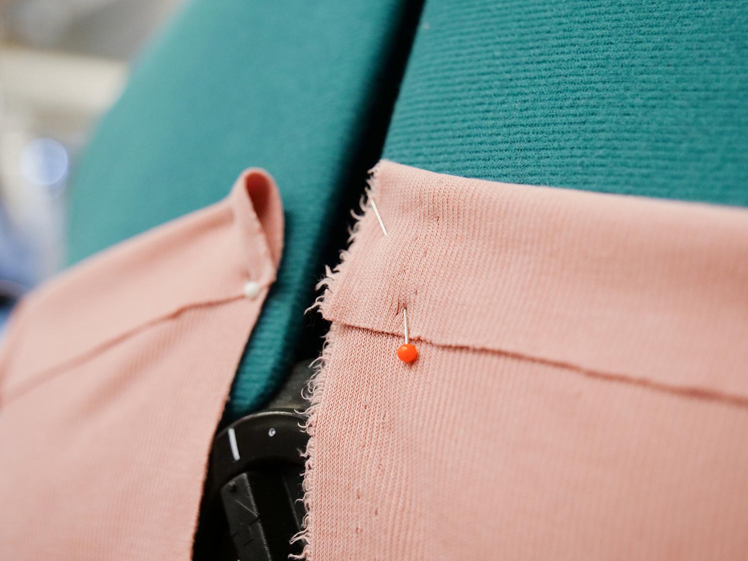 Fabric being pinned together before being sewn