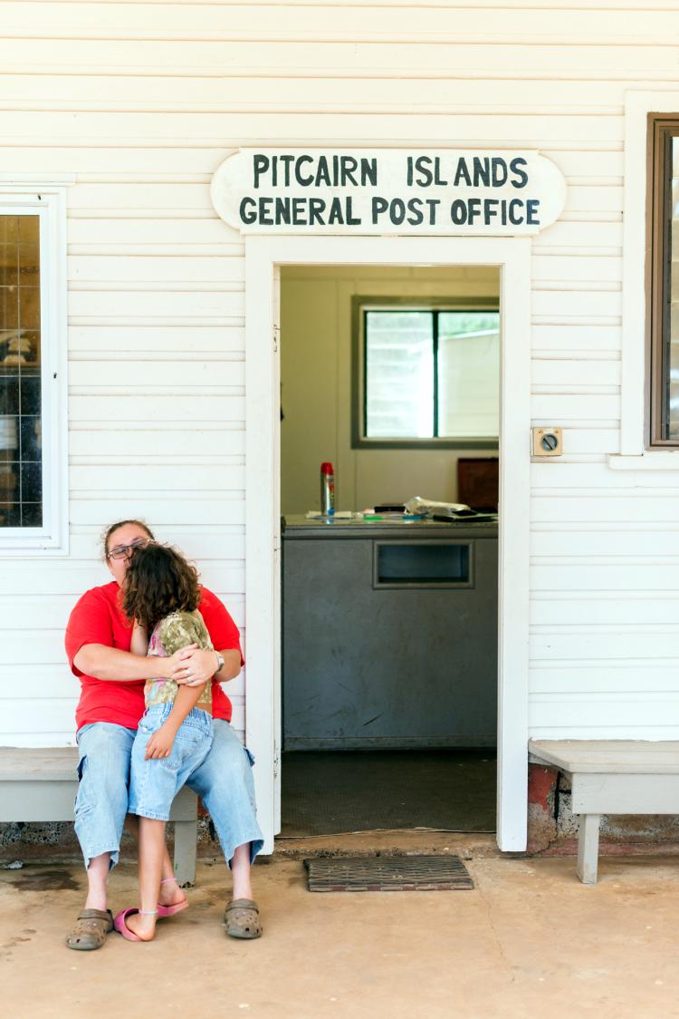 Charlene and Cushana Warren outside the Pitcairn Islands General Post Office in the  town square. When Davenport visited in 2014, Cushana was the last child left on  Pitcairn Island.