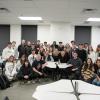 Coach Prime poses with students after his guest lecture.