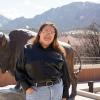 Nic Tamayo with a buffalo statue and the Flatirons in the background.