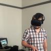 Student uses a virtual reality headset and handsets.