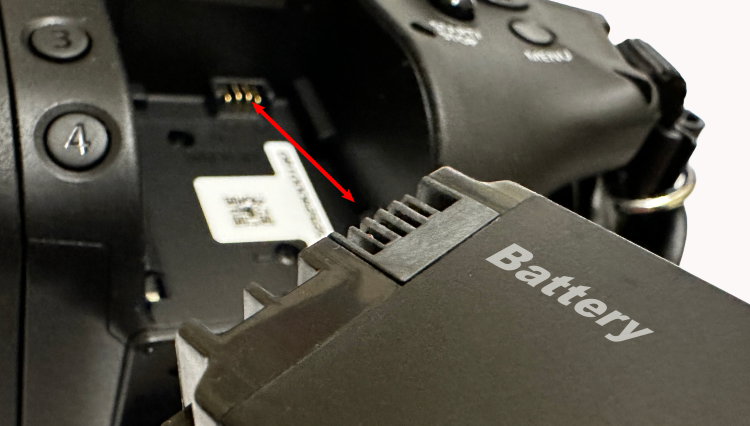Battery being inserted into camera