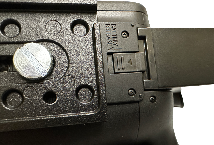 Bottom view of a camera showing the release latch