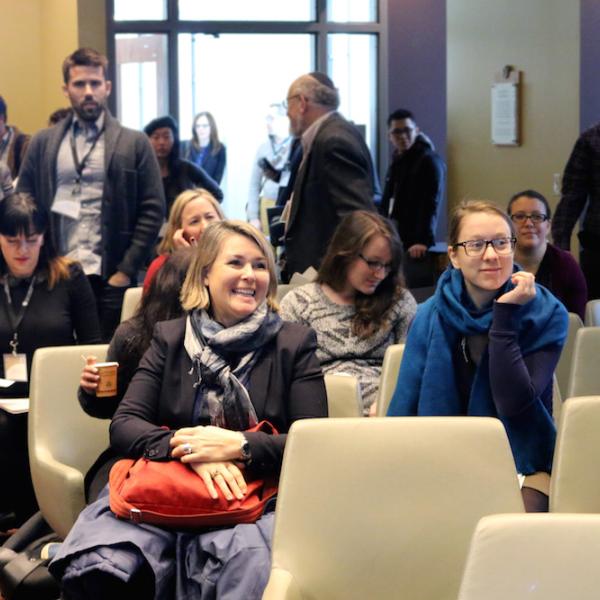Audience waits for next presentation.