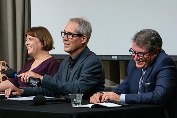 Closeup of three panelists behind a table.