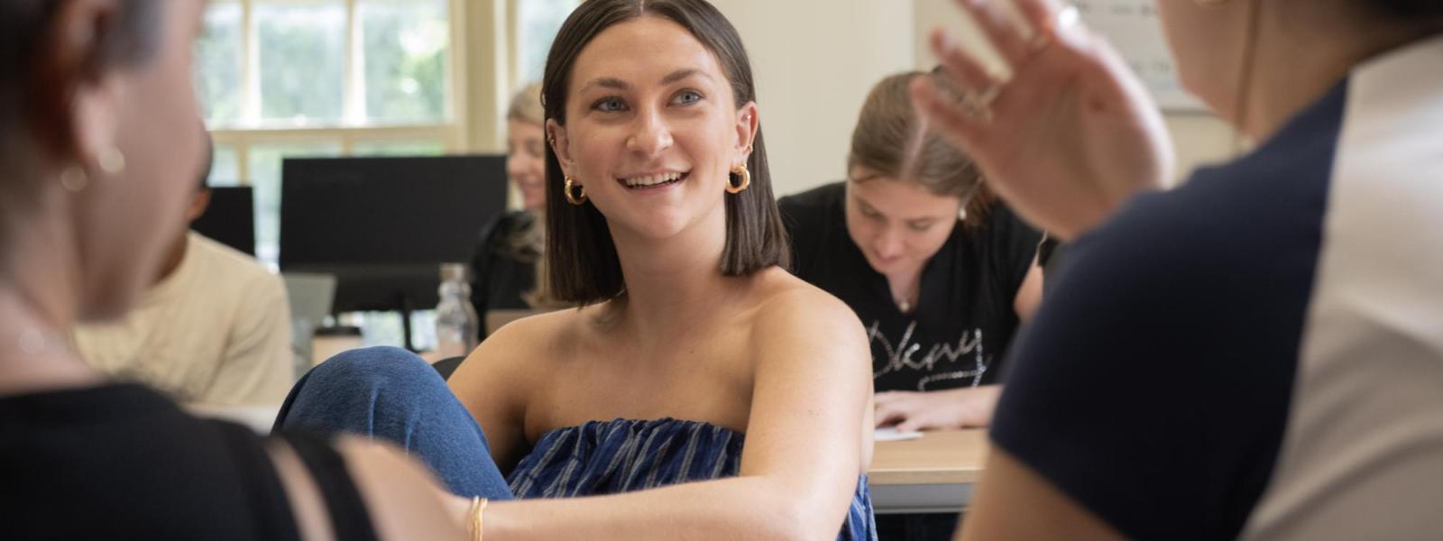 A student listens as one of her peers speaks in class.