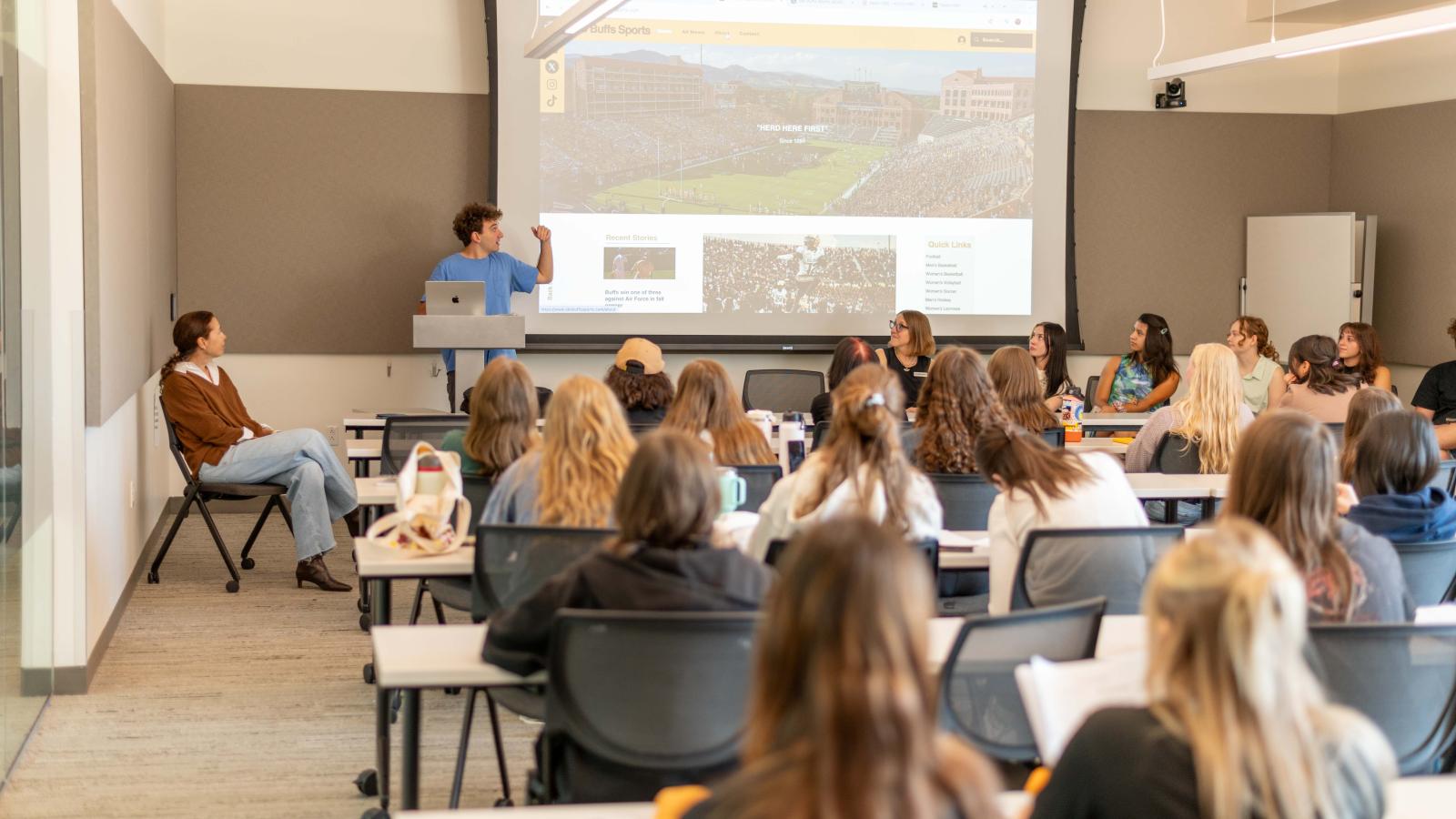 Student media leaders present in front of a packed classroom.