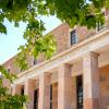 The Norlin Library framed by leaves from a nearby tree.