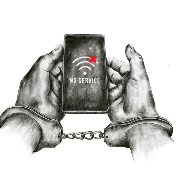 handcuffed hands holding a phone that says no service