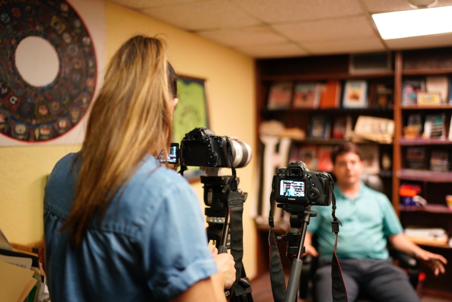 Tessa Diestel interviews Tim Gamwell, director of the Guatemalan-Maya Center in West Palm Beach, Florida. Photo by Angel Mendoza.