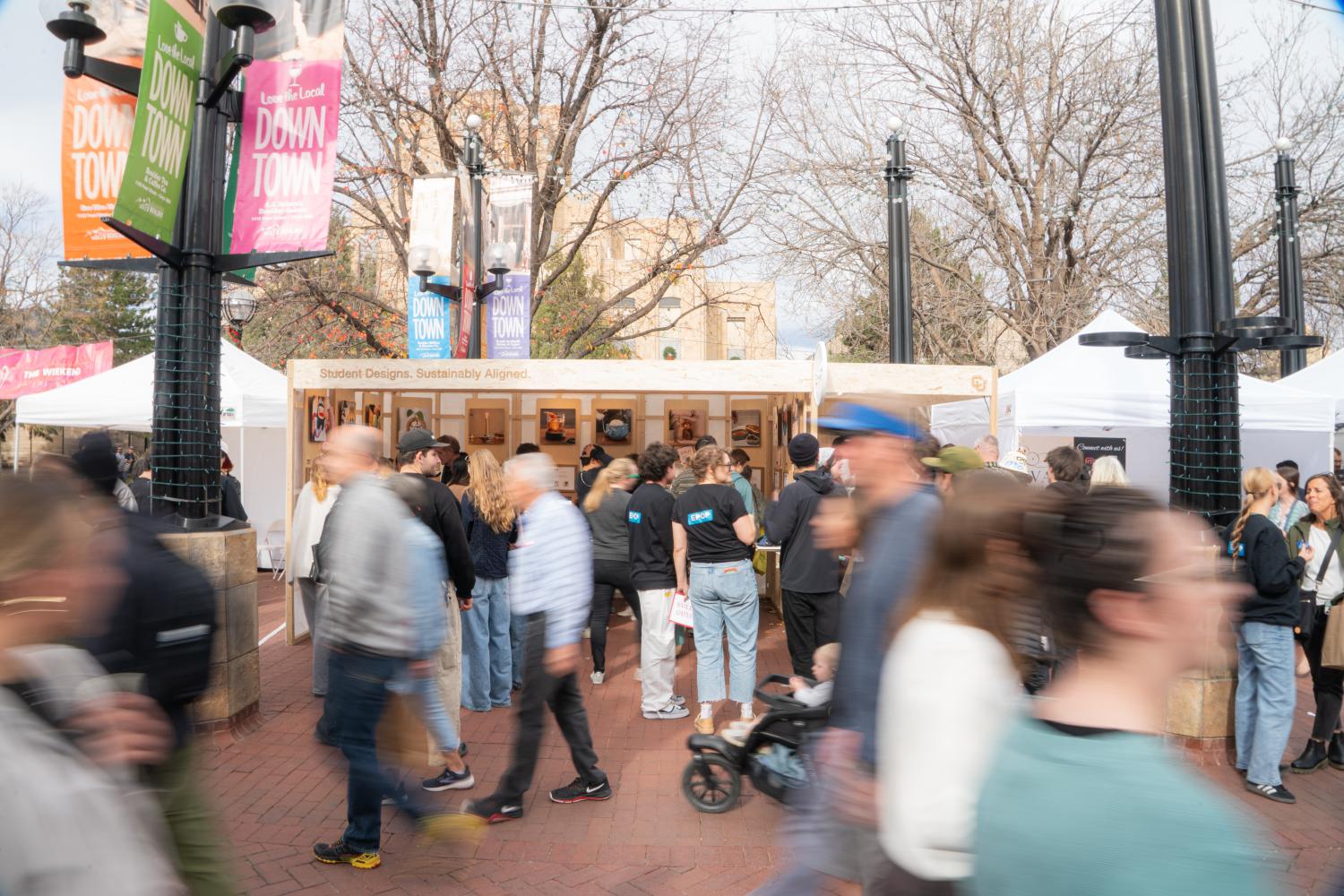 A crowd of people walking in front of the EPOP shop